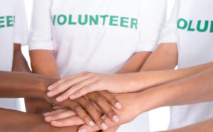 Group of female volunteers with hands together